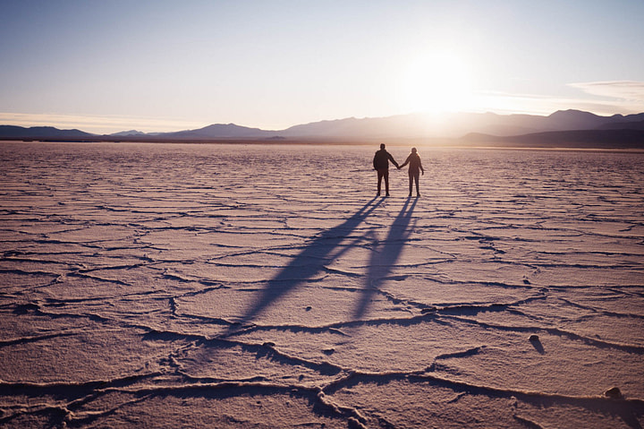 Silhouette of Maxine and Theo at sunrise on the salt flats of Salinas Grandes. Jujuy Province - Argentina