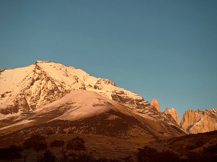 A snow capped sunrise bathe the mountains at the start of our hike towards Mirador base de Las Torres