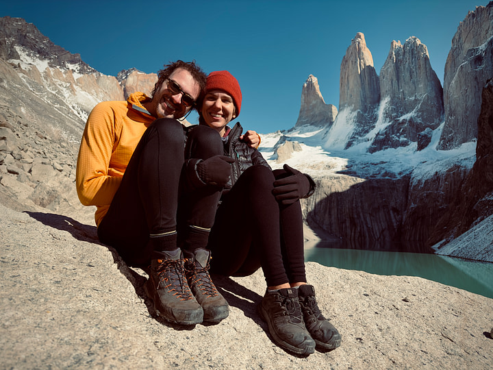 Maxine and Theo sitting together in front of the famous Torres del Paine at Mirador Torres del Paine