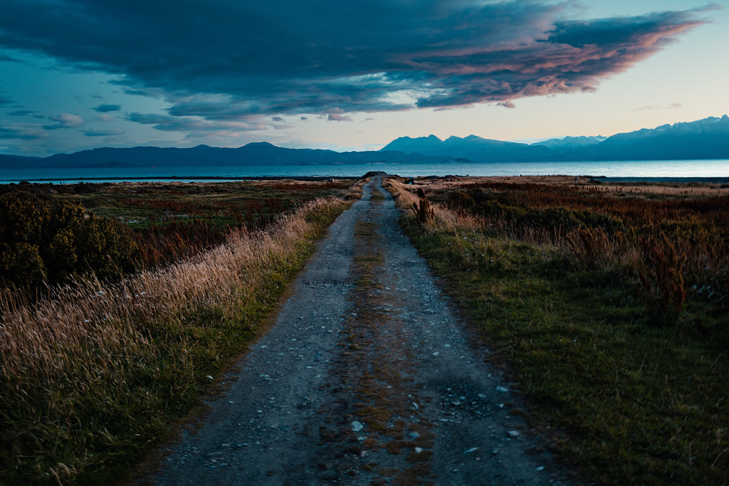 two tyre tracks leading to the end of the world, Ushuaia against a moody purple sky