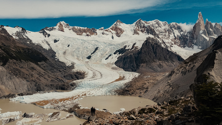 Maxine and Theo in front of Laguna Torre with the Glacier Grande and Cerro Torre Mountain Ranges in the background. Parque Nacional Lost Glaciares (Glacier National Park), Argentina