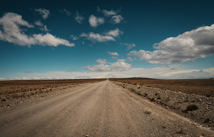 Expanse of the Patagonian estepe. The road disappears in the distance.